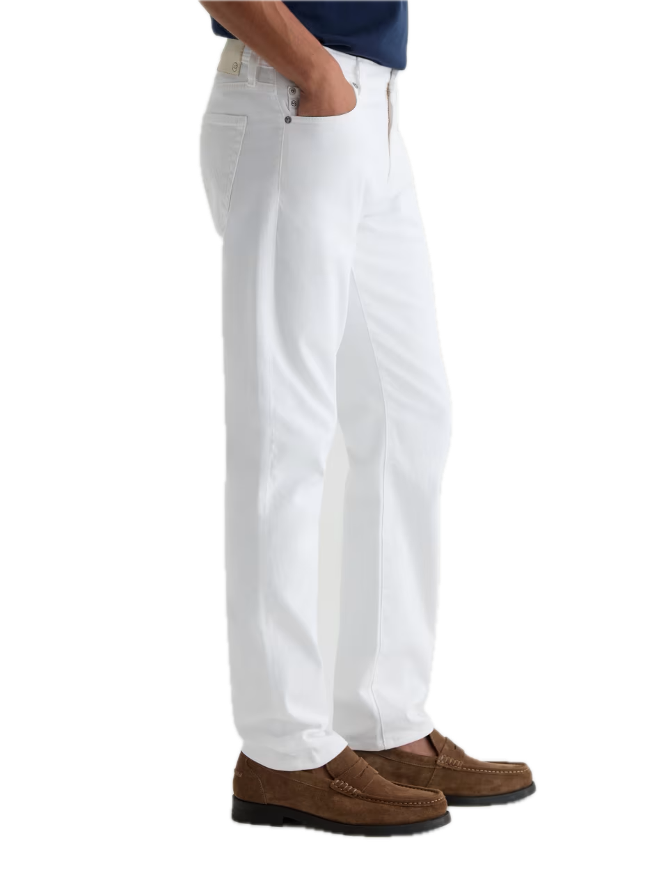 A person is shown standing with one hand in a pocket against a plain white background, wearing AG Jeans’ Tellis Cloud Soft Denim™ Jeans in a slim fit, paired with a dark blue shirt and brown loafers.