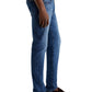 A man in AG Jeans Tellis Modern Slim Denim in medium blue, paired with a white shirt and brown loafers, stands with his arms relaxed at his sides.