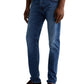 Someone is standing against a plain background wearing AG Jeans Tellis Modern Slim Denim in medium blue, paired with a white shirt and brown loafers.