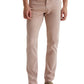 A man wears AG Jeans' Tellis Modern Slim Sueded Stretch Sateen light pink pants with five pockets, perfectly paired with a white shirt and brown suede loafers.