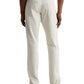 A person shown from the back wears AG Jeans Everett Slim Straight Leg men's pants in off-white cotton-linen twill with brown loafers.