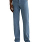A person wearing AG Jeans Everett Slim Straight with a classic five-pocket design, a white shirt, and tan loafers stands with one hand in their pocket against a plain background.