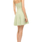 Someone in a light green Staud Wylie Mini Dress made of cotton poplin and white shoes stands, facing away.