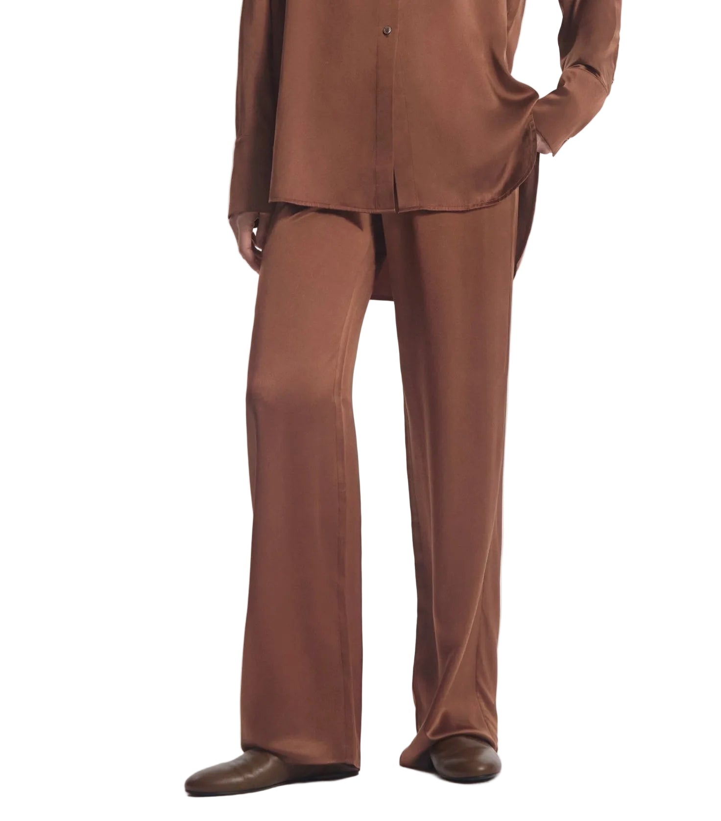 A person wearing the CO Elastic Silk Pant in brown with a matching long-sleeve shirt, styled with brown shoes.