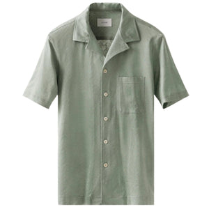 The Eton Green Knitted Resort Shirt features short sleeves, a single chest pocket, and a stylish resort collar, crafted from luxurious interlock knit in light green and shown on a white background.