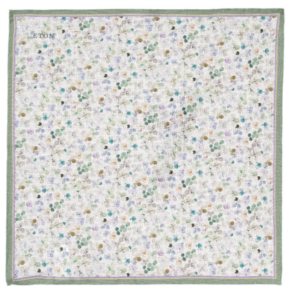 The Eton Light Green Floral Linen Pocket Square features a vibrant polka dot design on white with a green border, embroidered with "Eton" in one corner, ideal for spring attire.