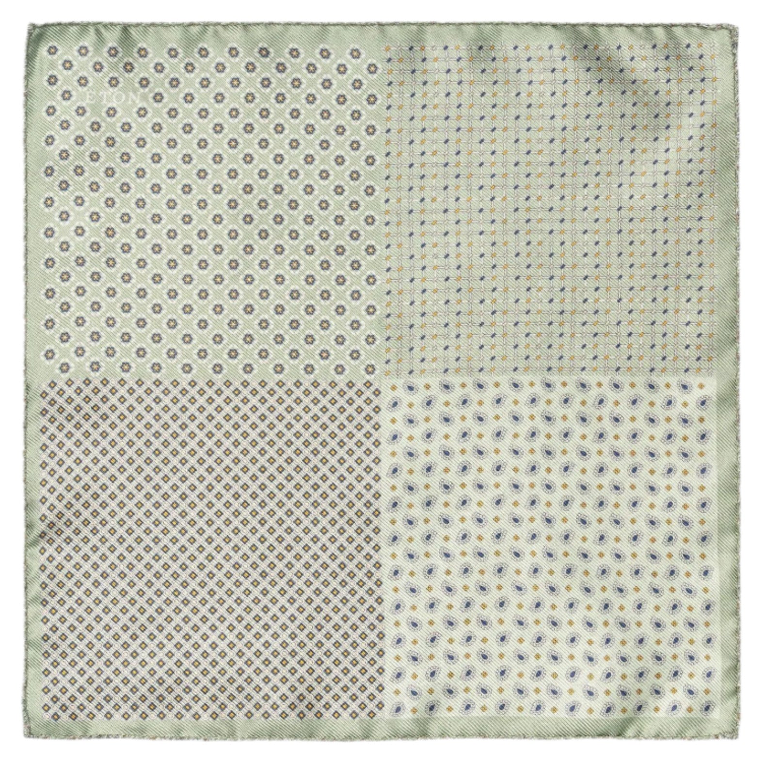 The Eton Mid Green 4-Sided Silk Pocket Square features a refined design with small dots, geometric shapes, and floral motifs in an elegant green and beige color scheme, offering sophisticated sartorial flair.