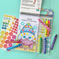 Bright Stripes’ Art on the Go! coloring set includes crayons, dot stickers, and a fun pad with creative activity pages—like a cartoon hermit crab to decorate—for colorful art adventures anywhere!.