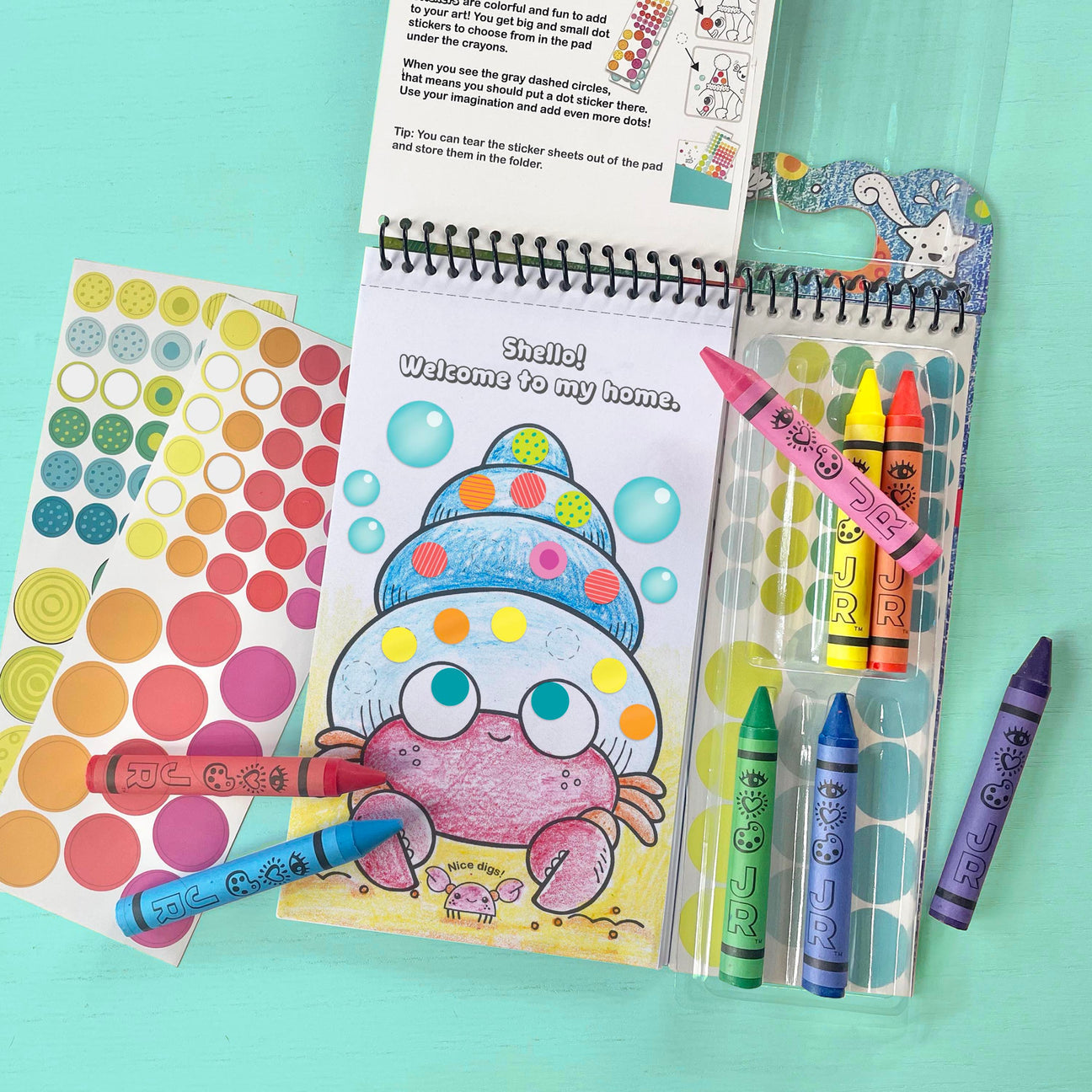 Bright Stripes’ Art on the Go! coloring set includes crayons, dot stickers, and a fun pad with creative activity pages—like a cartoon hermit crab to decorate—for colorful art adventures anywhere!.