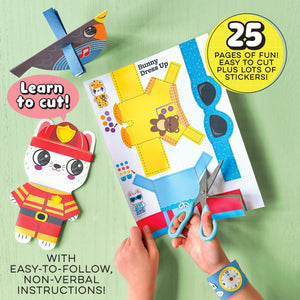 A child uses Bright Stripes’ Art on the Go Cut & Create kit to cut out a colorful paper outfit for an animal character, building scissor skills among a variety of paper crafts and scissors, with easy-to-follow instructions and stickers spread out on a green surface—ideal for any kids activity kit or young 3D craft enthusiasts.