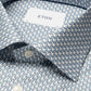 Close-up of the Cut Away Slim Signature Twill Parrot Shirt by Eton, featuring neatly folded blue and white interlocking chain patterns. Fabric ensures a wrinkle-free finish with visible buttons at the collar.