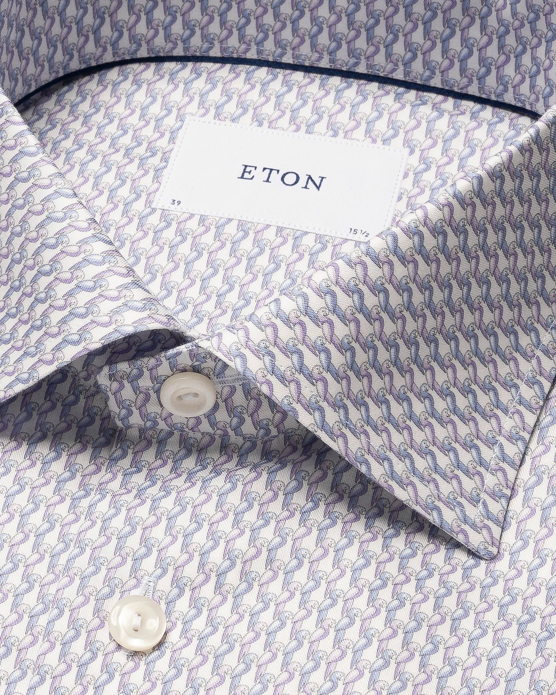 Close-up of an Eton's Cut Away Slim Signature Twill Parrot Shirt, made from extra-long staple cotton. This patterned shirt is wrinkle-free, features a cut-away collar, and buttons along the placket.