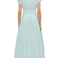 A woman models the Simkhai Farlow Dress, a light blue cotton faille midi with short sleeves and a fitted waist, offering a polished, understated look from the back.