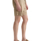A person in AG Jeans Oliver Short beige drawstring shorts with an adjustable waist and brown sandals stands sideways against a white background.