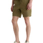 Someone wearing the AG Jeans Oliver Short, made from a breathable twill blend with an adjustable drawstring waist, pairs it with a white t-shirt and beige sneakers while standing against a plain background.