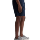 A person wearing a gray t-shirt, navy blue Archie Short from AG Jeans—crafted from premium Sorrento Stretch Twill Italian fabric—and gray sneakers stands against a plain white background.