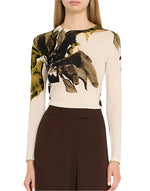 A person wearing a Jason Wu Collection Merino Wool Crewneck Sweater with abstract floral patterns in black and yellow, paired with brown pants.