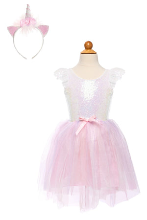 The Great Pretenders Girls' Dreamy Unicorn Dress features a pastel pink and white design with a sequined bodice, pink tulle skirt, bow accent, and includes a matching unicorn headband with ears and a horn.