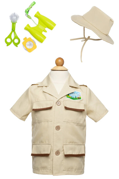 The Forest Guardian Set with Accessories by Great Pretenders is inspired by a classic kids park ranger costume and includes a beige shirt, matching hat, toy binoculars, magnifying glass, whistle, and bug viewer—all displayed on a wooden dress form.