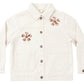 The Girls’ Denim Chore Coat by Rylee & Cru features an off-white button-up design with brown flower appliqués on the left chest, right shoulder, and left elbow. With front pockets and a classic collar, this jacket pairs timeless style with playful floral details.