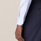 Close-up of a person wearing an Eton Light Blue Signature Twill Shirt in a slim fit, distinguished by its wrinkle-free fabric, paired with navy blue pants. The person's hand is relaxed by their side.