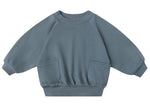 The Quincy Mae Baby Boys' and Boys' Pocket Sweatshirt in blue features long sleeves, two front pockets, ribbed cuffs, gathered sleeves, and a ribbed waistband, shown against a white background.