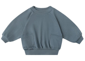 The Quincy Mae Baby Boys' and Boys' Pocket Sweatshirt in blue features long sleeves, two front pockets, ribbed cuffs, gathered sleeves, and a ribbed waistband, shown against a white background.
