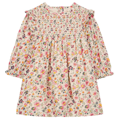 The Louise Misha Girls' Saralou Dress is a long-sleeved cotton gauze dress for children with a ruffled collar, smocked chest, and multicolored floral print on a light background.