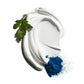 A swirl of white cream with a green parsley leaf and a small pile of blue powder on a white background, representing Jack Black’s Double-Duty Face Moisturizer—a lightweight formula enriched with antioxidants and broad-spectrum SPF 20.