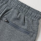 Close-up of the Boys’ Oceanside Tech Short by Rylee & Cru in gray, featuring an elastic waistband and a zip back pocket with a black pull tab, photographed on a light background to highlight these comfortable and convenient everyday essential shorts.