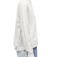 Side profile of a person wearing a 3.1 Phillip Lim Merino Knit Top pullover and embellished jeans.