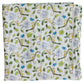 The Timo & Violet Shawl Blanket is a folded white organic cotton baby accessory with a playful print of monkeys, green leaves, and branches in shades of green, brown, and purple—ideal for adding style to any nursery.