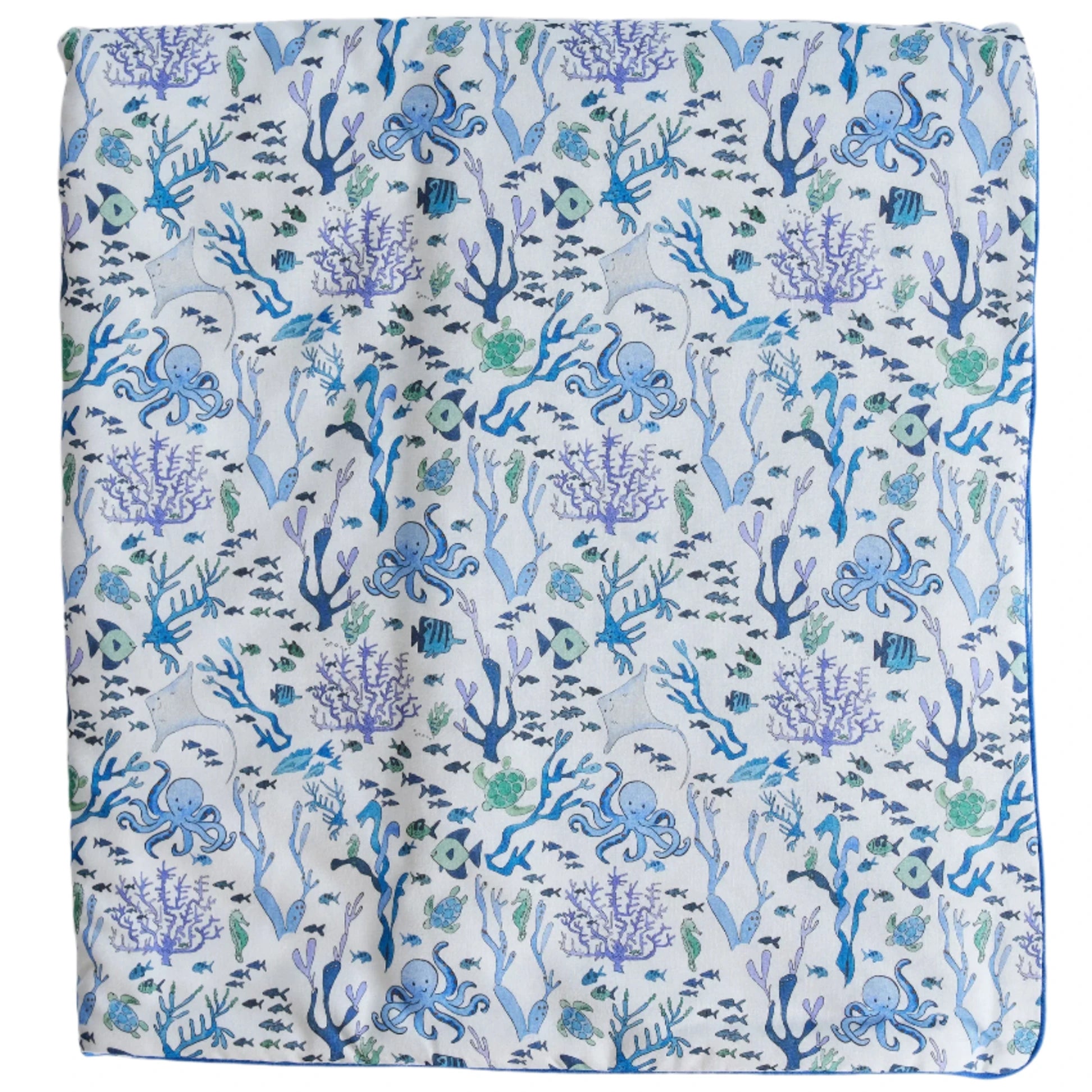 The Timo & Violet Crib Quilt is a square cloth with octopuses, fish, coral, and seaweed in blue, green, and purple on white—an eco-friendly bedding choice for your nursery.