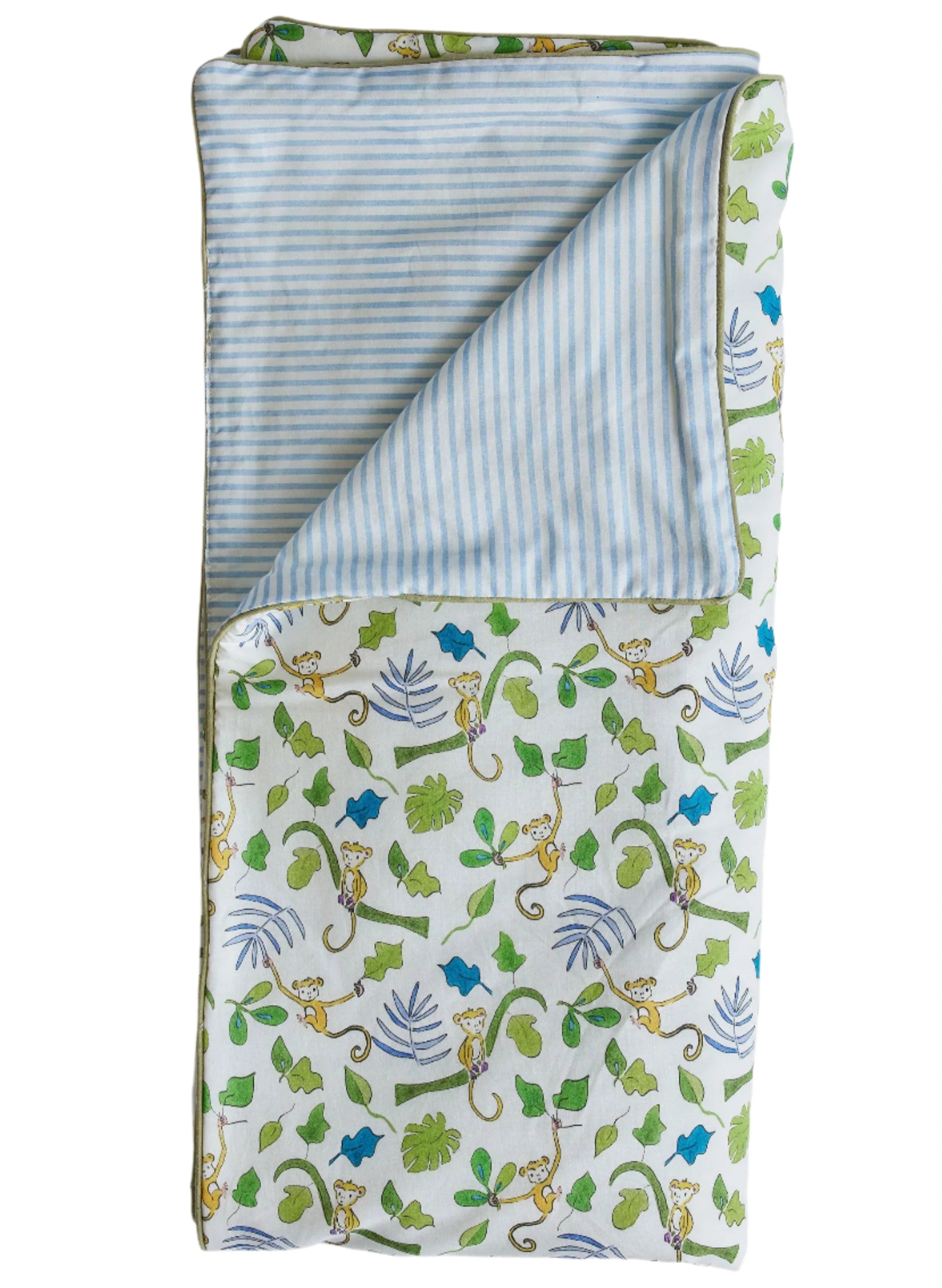 The Timo & Violet Crib Quilt is reversible, with a blue and white striped underside and a top featuring monkeys and leaves in green, blue, and yellow.