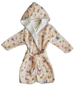 The Timo & Violet Kids' Bathrobe is made from ultra-soft velour cotton terry, featuring a light beige background with a colorful Coral Reef butterfly print and a waist belt.
