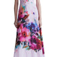 Person wearing a Lela Rose Watercolor Floral Cotton Voile Isabel Dress by Lela Rose made from airy cotton voile with short sleeves and a deep V-neck, paired with white shoes. The dress features a whimsical watercolor floral print.