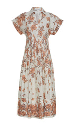 The Nash Midi Dress by Cara Cara is a fit and flare midi shirt dress with a beige base, brown floral print, collared neckline, and short sleeves.