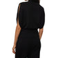 A woman wears the Lisa Yang Zaya Top—a black, sleeveless cashmere high-neck—paired with matching black pants, photographed from the back.