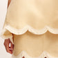 A close-up of a person wearing the POSSE Essie Top. Only the lower body and part of one hand are visible.