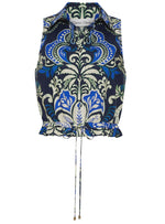 The Hannah Top by Cara Cara is a sleeveless collared halter with a blue, green, and white ornate floral pattern, featuring a button-down bodice and an adjustable drawstring hem.