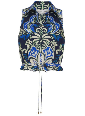The Hannah Top by Cara Cara is a sleeveless collared halter with a blue, green, and white ornate floral pattern, featuring a button-down bodice and an adjustable drawstring hem.