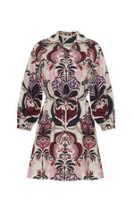 The Cara Cara Henry Dress is a long-sleeved, button-down dress with a collared neckline, featuring an ornate pink, burgundy, and black pattern on a light background.