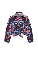 The Cara Cara Rumson Top is a printed long sleeve shirt with a pink, blue, and navy floral pattern, button-down collar, and a stylish front tie knot.
