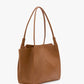 The Small Victoria Tote by Victoria Beckham features smooth brown tan calf leather, double shoulder straps, and minimal stitching, shown against a plain white background.