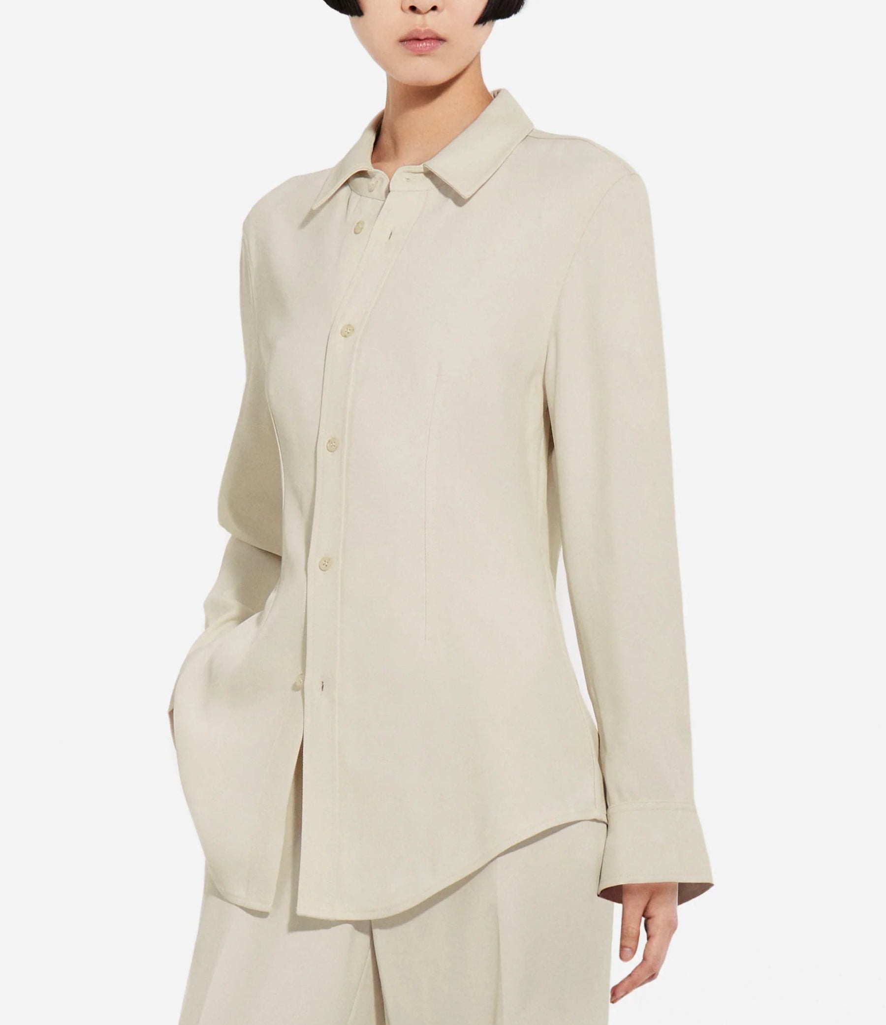 A person wears the CO Fitted Collared Shirt in beige with matching pants, standing against a plain white background.