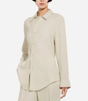 A person wears the CO Fitted Collared Shirt in beige with matching pants, standing against a plain white background.