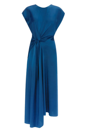 The Aria Midi Dress by Victoria Beckham is a sleeveless blue dress made from luxurious crepe-back satin, designed with a round neckline and an asymmetrical draped knot accent at the waist. Its flowing, mid-length skirt lends an elegant silhouette ideal for any occasion.