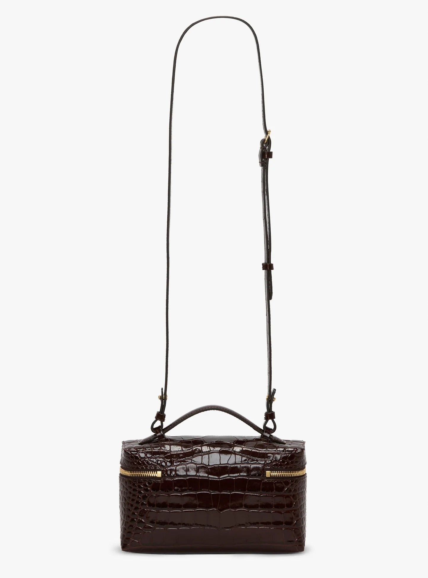 The Vanity Croc Crossbody by Victoria Beckham is a dark brown rectangular bag in croc-embossed leather, with a gold zipper, short top handle, adjustable strap, and organized compartments for convenience.