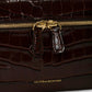 Close-up of the Victoria Beckham Vanity Croc Crossbody, featuring dark brown croc-embossed leather, gold zipper, organized compartments, and a gold "Victoria Beckham" logo.