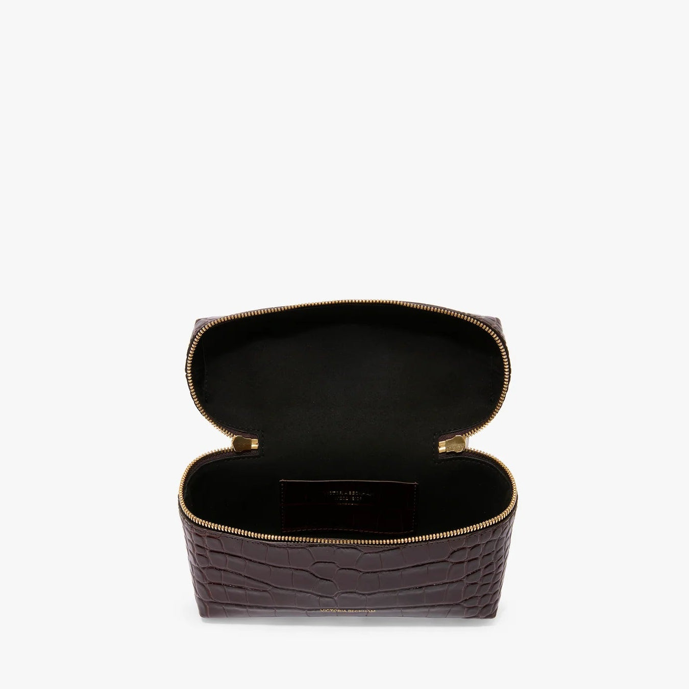 The Vanity Croc Crossbody by Victoria Beckham features dark brown croc-embossed leather in a rectangular shape with a gold zipper, and opens to a black interior with an inner pocket for organization.